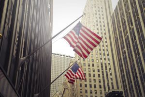 Shot of two American or US flags on a high rise building